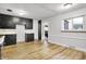 Bright kitchen featuring black cabinets, laminate floors, and a window providing natural light at 3975 Denwood Dr, Indianapolis, IN 46226