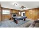 Retro living room with wood paneling, fireplace, and a pool table at 3975 Denwood Dr, Indianapolis, IN 46226