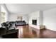 Spacious living room showcasing hardwood floors, a decorative fireplace, large windows, and a neutral color palette at 3975 Denwood Dr, Indianapolis, IN 46226