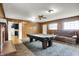 Retro living room with wood paneling, a fireplace, a pool table, and cozy seating at 3975 Denwood Dr, Indianapolis, IN 46226