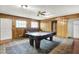 A charming living room with wooden paneling, a pool table, and a cozy sofa at 3975 Denwood Dr, Indianapolis, IN 46226