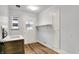 Mud room featuring laminate flooring, shelving, and a window for natural light at 3975 Denwood Dr, Indianapolis, IN 46226