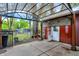Covered patio featuring an opened door with a view of the lush outdoor foliage at 3975 Denwood Dr, Indianapolis, IN 46226