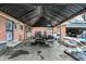 Cozy covered patio with outdoor seating and room for entertaining, adjacent to a brick home at 3975 Denwood Dr, Indianapolis, IN 46226