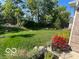 Well-maintained backyard with a lush green lawn and colorful flower beds at 4281 Cairo Way, Avon, IN 46123