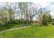 Lush backyard featuring a stone path, mature trees, and a serene garden area for outdoor enjoyment at 4281 Cairo Way, Avon, IN 46123