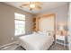 Neutral bedroom with a ceiling fan, window, Murphy bed and carpet at 4281 Cairo Way, Avon, IN 46123
