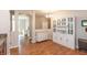 Bright dining area with hardwood floors, custom cabinetry, and stylish chandelier lighting at 4281 Cairo Way, Avon, IN 46123