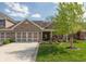 Charming brick home with well-manicured lawn, two-car garage, and a welcoming front porch at 4281 Cairo Way, Avon, IN 46123