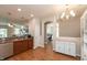 Well-lit kitchen with stainless steel appliances, wood flooring, and a view into other rooms at 4281 Cairo Way, Avon, IN 46123