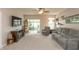 Cozy living room with plush reclining sofa, arm chair, ceiling fan, and large windows at 4281 Cairo Way, Avon, IN 46123