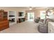 Open concept living room showcasing a TV, furniture, decor, and access to a bedroom and patio at 4281 Cairo Way, Avon, IN 46123