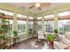 Bright sunroom with many windows, tile floor, ceiling fan, and views of landscaped yard at 4281 Cairo Way, Avon, IN 46123