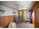 Bedroom with wood paneling and vintage-style decor at 4429 Iowa St, Clayton, IN 46118