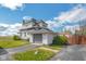 Rear elevation of a charming two-story home with an attached garage, and well-maintained lawn at 4429 Iowa St, Clayton, IN 46118