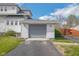 Attached garage with a paved driveway, enhancing the curb appeal of this charming property at 4429 Iowa St, Clayton, IN 46118