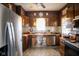 Eat-in kitchen features stainless steel appliances and dark wood cabinetry at 4429 Iowa St, Clayton, IN 46118