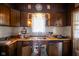 Kitchen sink featuring stainless steel appliances and dark wood cabinetry at 4429 Iowa St, Clayton, IN 46118
