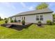Well-maintained backyard features a wooden deck, seating, fire pit, and lush landscaping at 4615 Copper Grove Dr, Indianapolis, IN 46237