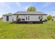 Backyard view of the home with a wooden deck, grassy yard, and a shed at 4615 Copper Grove Dr, Indianapolis, IN 46237