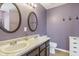 Elegant bathroom with dual vanities, oval mirrors, and neutral decor at 4615 Copper Grove Dr, Indianapolis, IN 46237