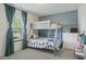 Shared bedroom featuring a bunk bed with vibrant blue accents and soft natural light at 4615 Copper Grove Dr, Indianapolis, IN 46237