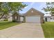 Lovely brick home featuring an attached two car garage, nice landscape, and spacious driveway at 4615 Copper Grove Dr, Indianapolis, IN 46237