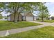 Traditional brick home with a two car garage and a long driveway with green grass at 4615 Copper Grove Dr, Indianapolis, IN 46237