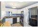 Modern kitchen with stainless steel appliances and light countertops with views to the backyard at 4615 Copper Grove Dr, Indianapolis, IN 46237