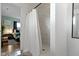 Modern bathroom featuring white-tiled shower, and a glimpse into a stylish bedroom, creating a serene and functional space at 4720 E 42Nd St, Indianapolis, IN 46226