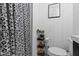 Modern bathroom featuring black and white patterned shower curtain and walls, creating a stylish and functional space at 4720 E 42Nd St, Indianapolis, IN 46226