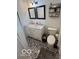 Stylish bathroom featuring a double vanity, black and white patterned tile floor, and modern decor at 4720 E 42Nd St, Indianapolis, IN 46226