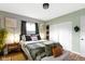 A stylish bedroom featuring neutral tones, wood floors, and decorative accents creates a calming retreat at 4720 E 42Nd St, Indianapolis, IN 46226
