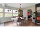 Bright dining room features an oval table, modern chandelier, and large windows with views of the lush backyard at 4720 E 42Nd St, Indianapolis, IN 46226