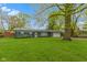 Charming single-story home with a well-maintained lawn and mature tree at 4720 E 42Nd St, Indianapolis, IN 46226