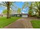 Charming single-story home features a well-manicured front yard, a driveway, and inviting curb appeal at 4720 E 42Nd St, Indianapolis, IN 46226