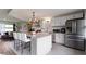 Kitchen island with white cabinets, stainless steel appliances, and bar stool seating at 4720 E 42Nd St, Indianapolis, IN 46226