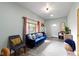 Inviting living room with plush blue sofa, comfortable seating, natural light, and stylish decor for a cozy atmosphere at 4720 E 42Nd St, Indianapolis, IN 46226