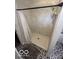 Tiled shower with marble-style tiles, black shower rod, and patterned tile floor at 4720 E 42Nd St, Indianapolis, IN 46226