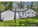 The backyard with white-sided house and garage, complemented by a green lawn at 4721 E Morris St, Indianapolis, IN 46203