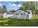 A spacious backyard with lush green grass and mature trees surrounding the property at 4721 E Morris St, Indianapolis, IN 46203