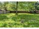 Expansive backyard featuring lush greenery and a sturdy wooden fence for added privacy at 4721 E Morris St, Indianapolis, IN 46203