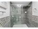 Bathroom shower stall featuring decorative tile accents, glass door, and modern fixtures at 4721 E Morris St, Indianapolis, IN 46203
