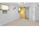 Bedroom featuring a unique yellow barn door, carpet, and a neutral color palette at 4721 E Morris St, Indianapolis, IN 46203