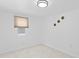 A bright bedroom with white walls and carpet, featuring a window and decorative wall art at 4721 E Morris St, Indianapolis, IN 46203