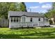 A quaint cottage-style house with a well-manicured lawn and a detached garage at 4721 E Morris St, Indianapolis, IN 46203