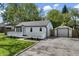 Charming home with a landscaped front yard, white picket fence, and detached garage at 4721 E Morris St, Indianapolis, IN 46203