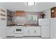 Well-lit kitchen with stainless steel appliances, backsplash, and white cabinetry at 4721 E Morris St, Indianapolis, IN 46203