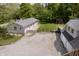 Backyard view features a well-maintained lawn, patio, mature trees, fence, garage and sheds at 503 E Bunker Hill Rd, Mooresville, IN 46158