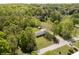 Aerial view of a charming home nestled in a lush green landscape surrounded by mature trees and other homes at 503 E Bunker Hill Rd, Mooresville, IN 46158